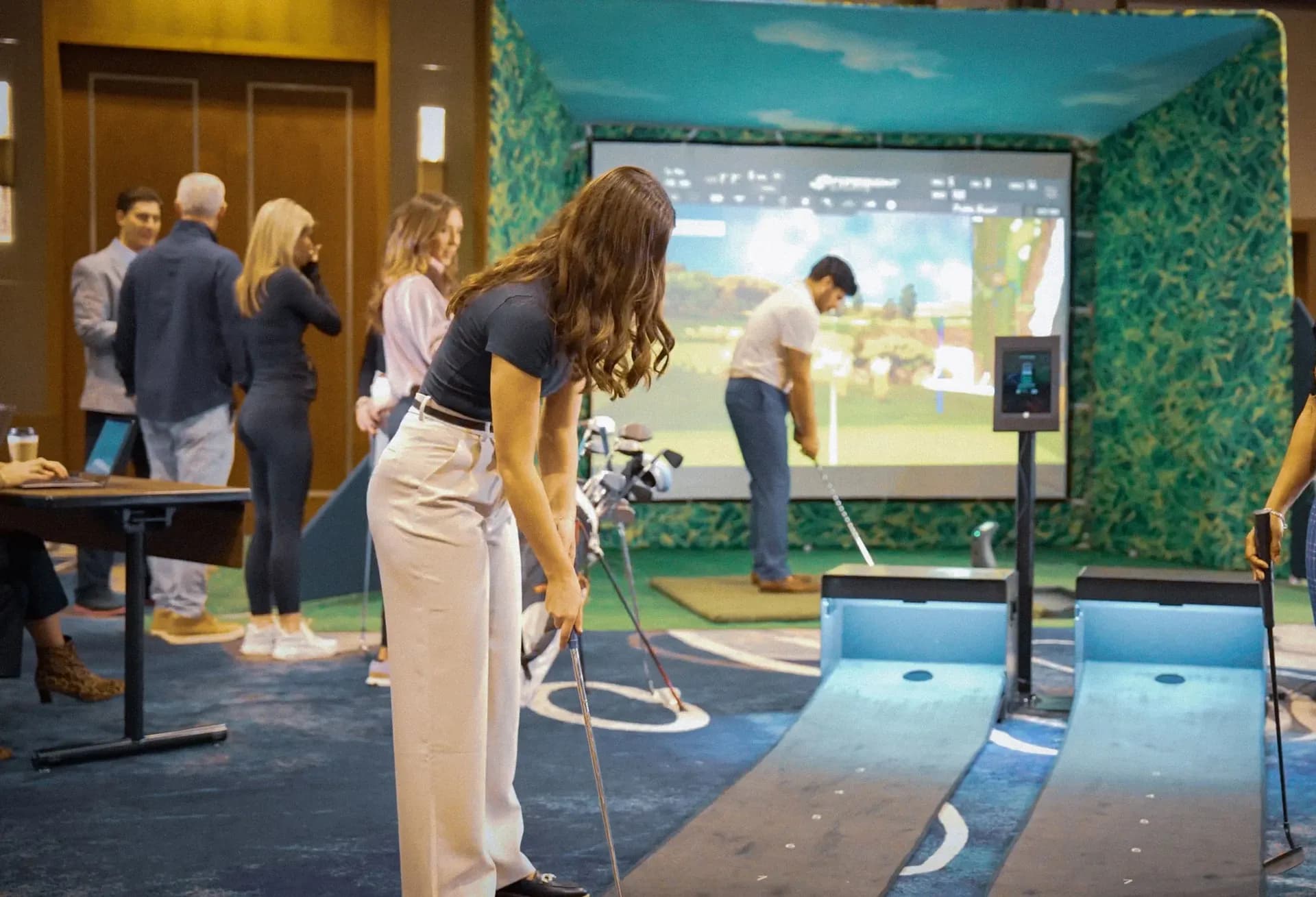 WeGo Golf simulator bay installed in an event space with branded enclosure